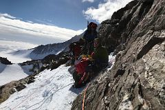 03B Resting In The Rock Band On The Climb Up The Fixed Ropes From Mount Vinson Low Camp To High Camp.jpg